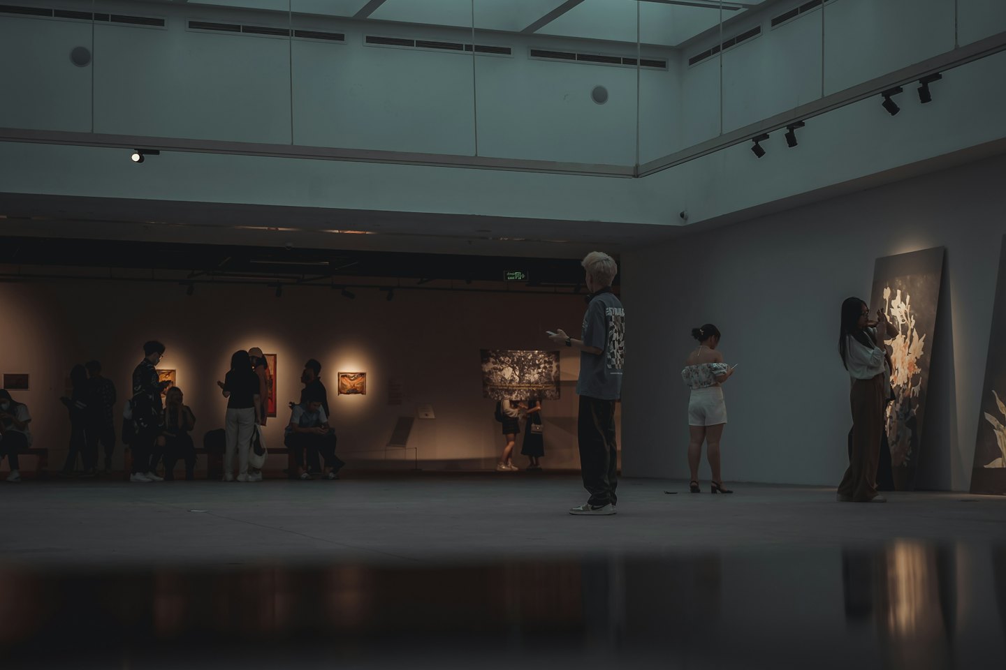 Diverse visitors engage with modern art in a gallery.