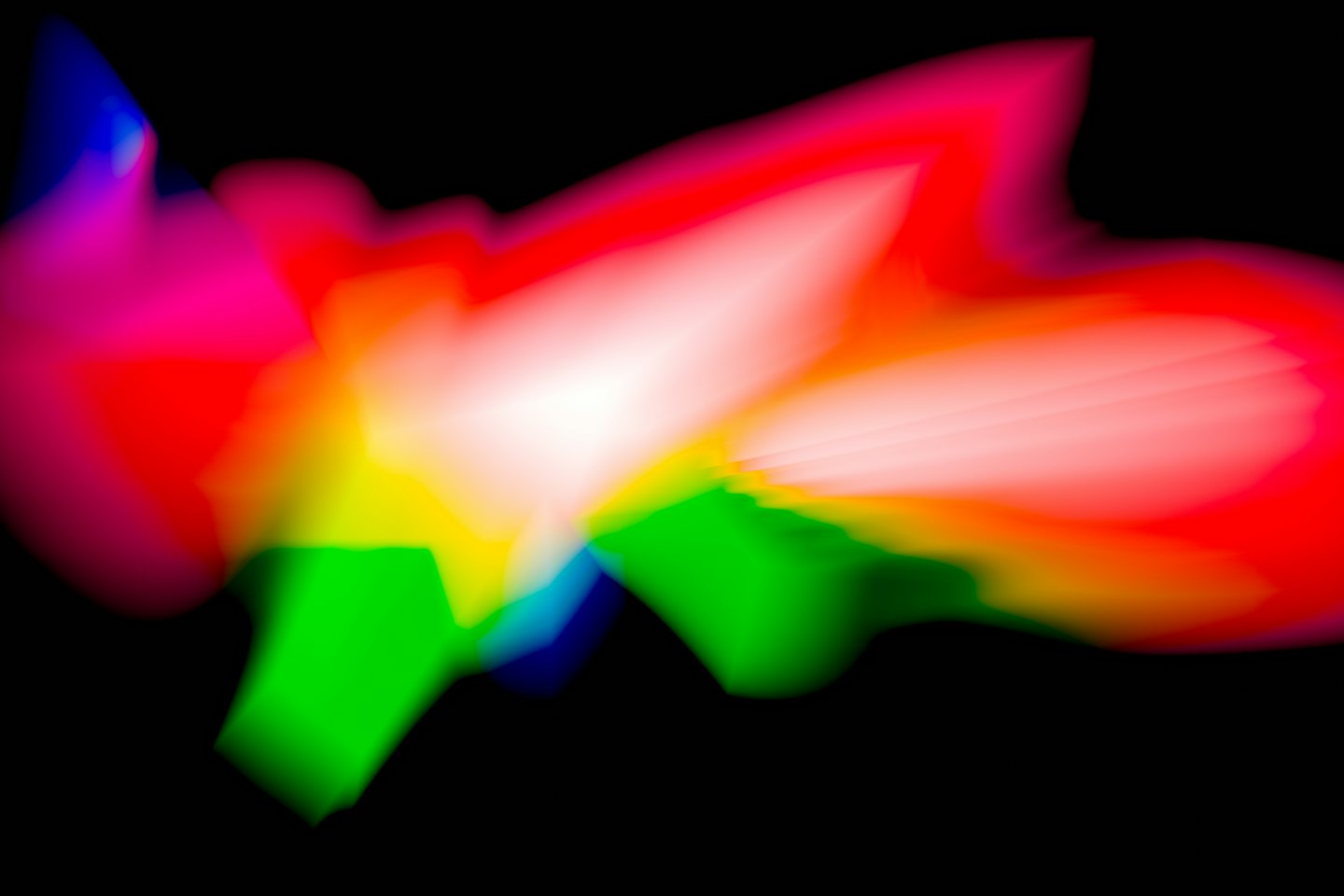 Dynamic streaks of colorful light swirl against a black background.