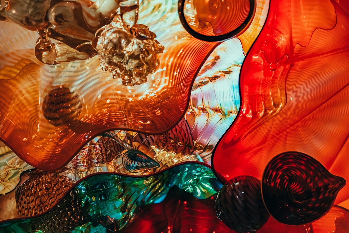 Swirling organic shapes of a colorful glass art sculpture.